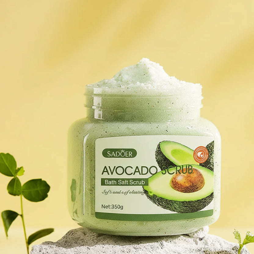 Jar of avocado bath salt scrub with avocado slices on a yellow background