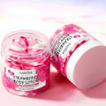 Strawberry body lotion with packaging on a pink background