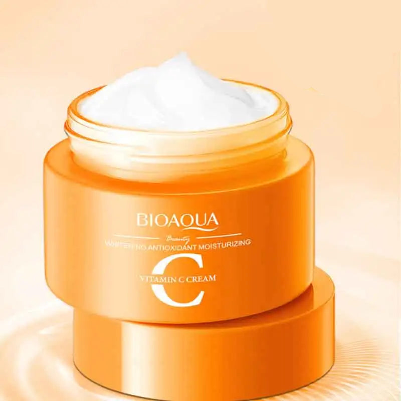 Orange jar of BIOAQUA Vitamin C cream with a white lid on a beige background