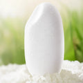 White cosmetic sponge with text and icons on a natural background
