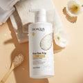 Bioaqua Rice Raw Pulp Body Wash bottle with rice raw pulp and wooden spoon on a beige background